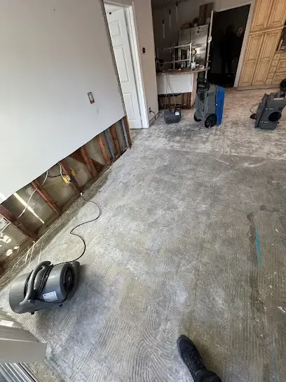Air movers drying a subfloor after the flooring was pulled up